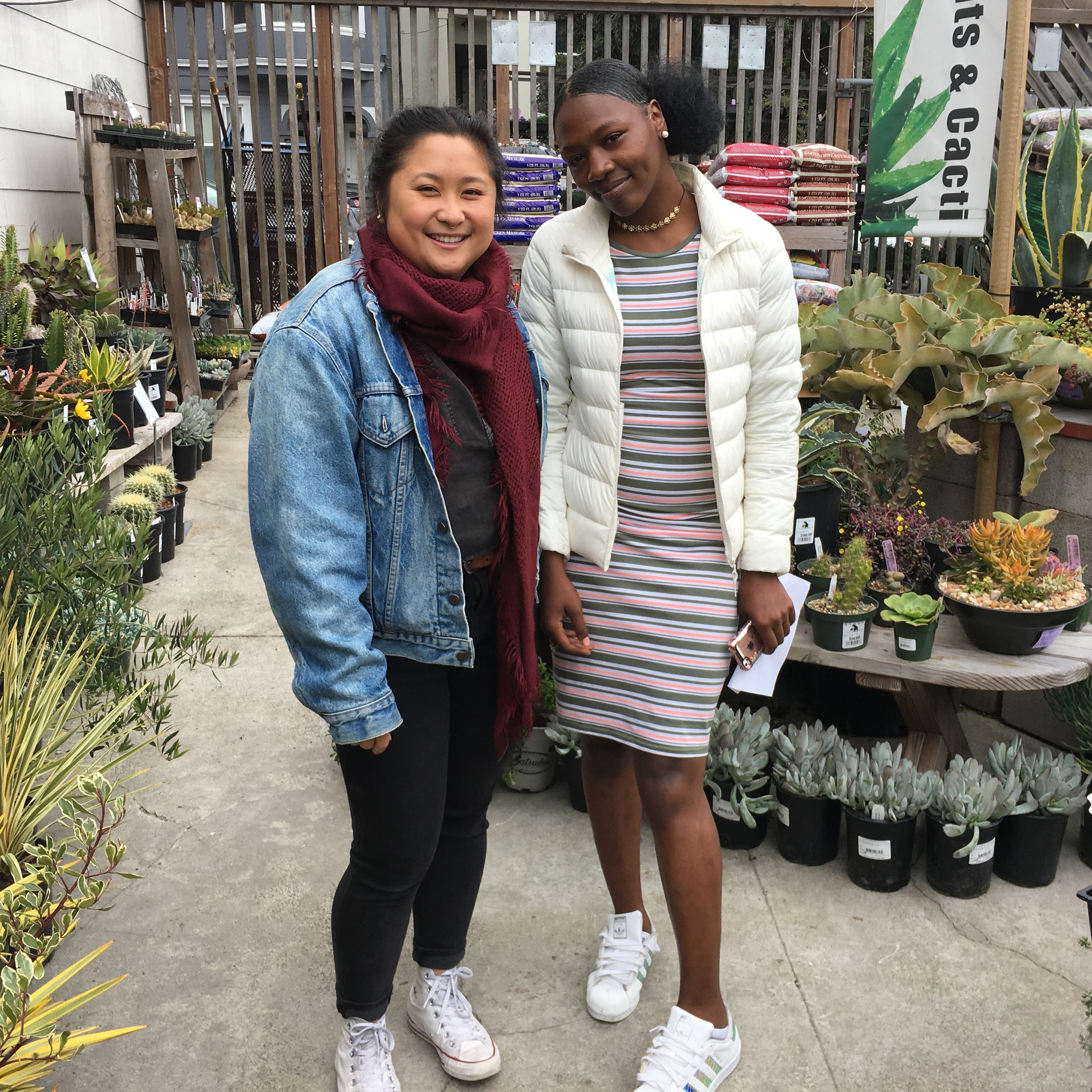 Trang and Brianna stop at a plant shop on an outing together.